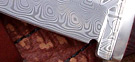DamaskaRaven - my special Raven model in damascene - a high performance patterned stainless powder steel. Damascene knife prices start at �320, model shown is �412 with a fully lined Cape buffalo hide sheath, prices on request. I can supply a knife with a fully lined Cape buffalo hide sheath (in any style) at an extra �58.